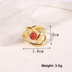 Detail showing irregular layered gold ring with red bead and diamond accent and dimensions