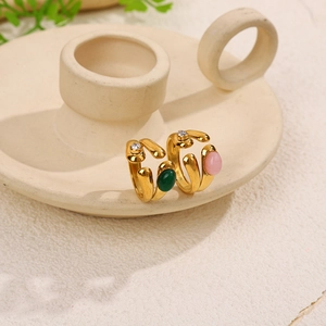 Close-up of vintage gold striped open rings with green and pink natural oval stones
