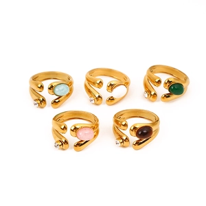 Set of 5 minimalist gold rings with oval faux stones in various colors on white background