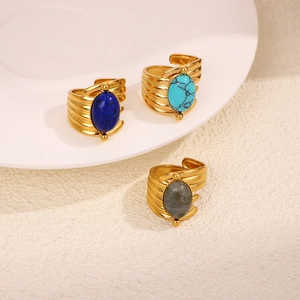 Detailed view of three vintage gold rings with lapis, turquoise, and labradorite stones