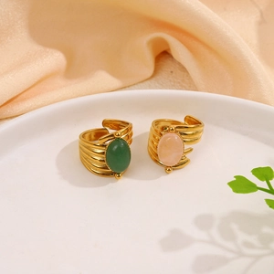 Detail of adjustable gold-plated stainless steel rings with green and pink natural stones