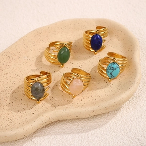 Detail of vintage bohemian open rings with colorful natural stones and ribbed gold bands
