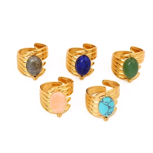 Collection of five gold titanium steel rings with assorted colorful natural gemstones