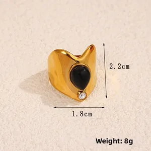 Detailed view of vintage gold ring with black teardrop stone and 2.2cm height scale