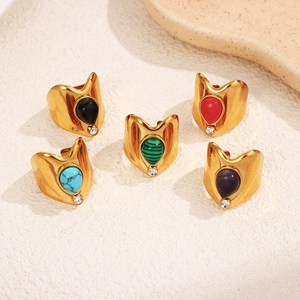 Detail of vintage teardrop natural stone rings in various colors with gold plating