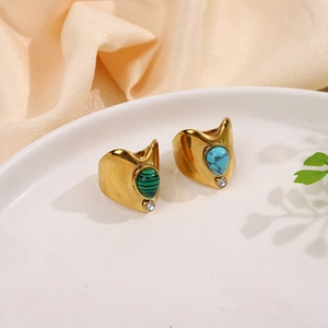 Detail of vintage gold-plated rings with drop-shaped green malachite and turquoise stones