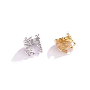 Macro detail of gold and silver organic wave rings with irregular lava texture finish
