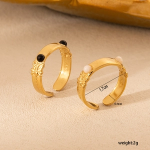 Detail of vintage 18K gold plated steel rings with floral patterns and bead inlays