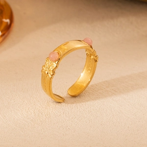 Detail of 18K gold-plated vintage ring with pink natural stones and floral carvings