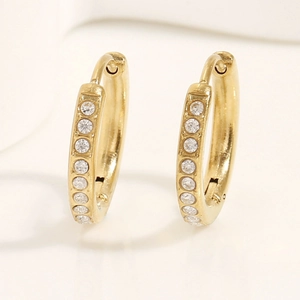 Detail of 14k gold plated hoop earrings with shimmering white zircon stones inlay