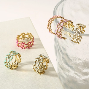 Detailed view of colorful enamel flower leaf rings in gold stainless steel finish