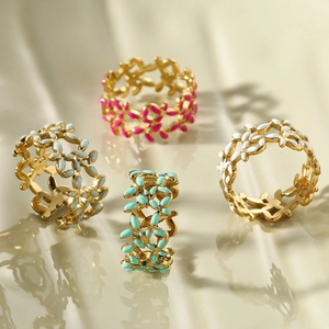 Detailed macro shot of hollow leaf rings with colorful enamel drippings in four colors