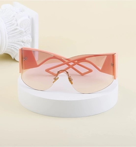 Detail of Y2K frameless sports sunglasses featuring orange gradient lenses and geometric arms