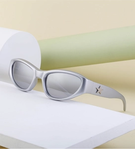 Close-up of matte silver Y2K sports sunglasses with star detail on stylish geometric stand