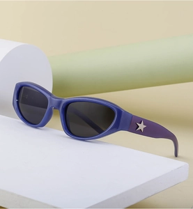 Close-up of Y2K star sunglasses with blue-purple gradient frame and silver metal star