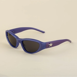 Detail of Y2K cat-eye sunglasses with gradient frames and silver star metal accents