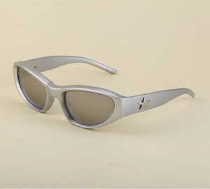 Detail of silver Y2K sunglasses frame featuring a metallic star decoration on the temple