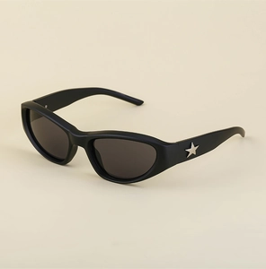 Close-up of black cat-eye sunglasses with silver star detail on matte frames