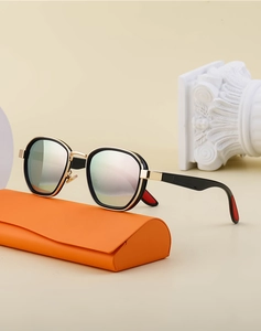 Polarized colorful oval sunglasses with gold frame on a premium orange display case