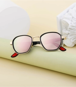 Detail of retro oval polarized sunglasses with rose gold lenses and black metal frames