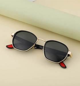 Detail of vintage polarized sunglasses with golden metal bridge and red temple tips