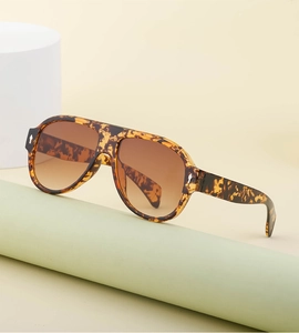 Detail of tortoise shell aviator sunglasses with brown gradient lenses and dual bridge