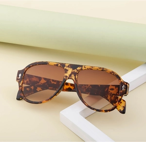 Detail of vintage aviator sunglasses with tortoise frame and silver arrow hardware accent