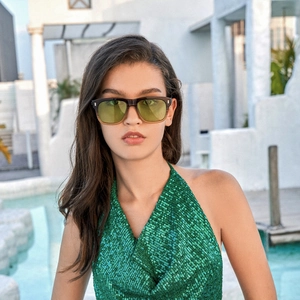 Close-up of stylish square sunglasses with gradient brown frames and amber lenses on model