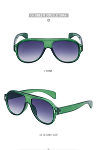 Detailed view of green aviator sunglasses with gray gradient lenses and side temple markings