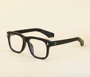 Detail view of square black spectacle frames featuring metallic accents and sleek finish