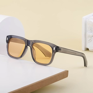 Retro square sunglasses with transparent grey frame and yellow lenses on display
