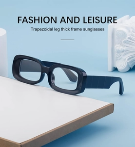 Side view of black thick frame sunglasses with wide trapezoidal legs on white display