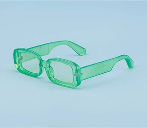 Detail of trendy green translucent square frame sunglasses with wide temples