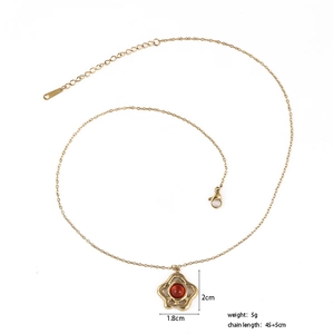 Detail view of flower pendant necklace with red gemstone and adjustable chain measurements