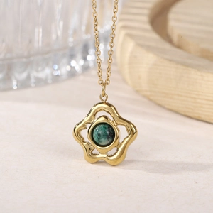 Close-up of gold hollow flower pendant necklace featuring green tiger eye gemstone