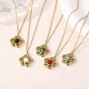 Close-up of five hollow flower necklaces with tiger eye and colorful stones on a stand