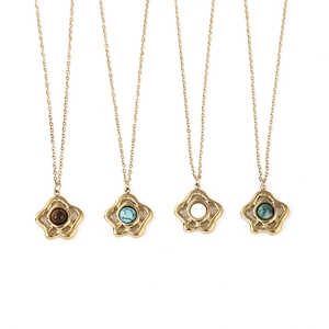 Detail view of four gold floral necklaces featuring tiger eye, turquoise, and green stones