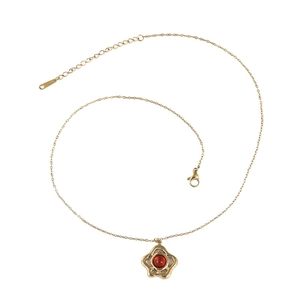 Elegant gold flower pendant necklace with tiger eye stone on white background