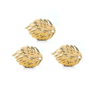 Macro view of 18K gold-plated leaf charms with realistic vein texture for DIY jewelry