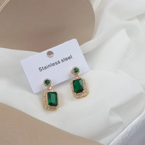 Detail of luxury emerald green zirconia earrings in gold plated stainless steel
