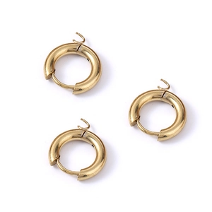 Close-up of three polished gold round earring charms with 925 hallmarks on white background