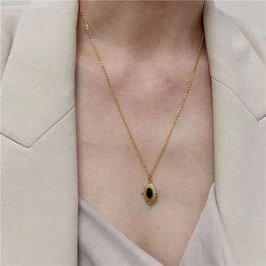 French vintage titanium steel necklace with black oval stone pendant on female model