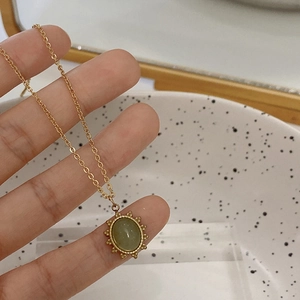 Vintage gold-plated titanium steel necklace with an oval green natural stone pendant