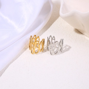 Detailed view of hollow floral pattern texture on gold and silver titanium rings
