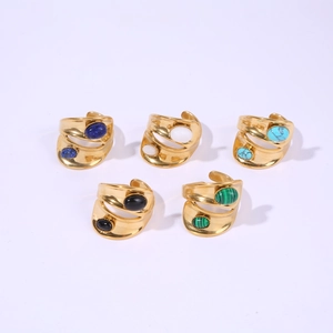 Detail of five gold wide-band rings with colorful oval stones on white background