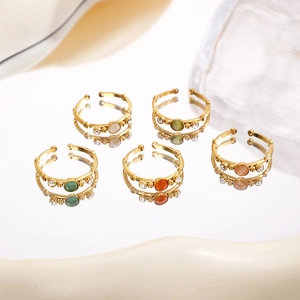 Set of five gold bamboo-style open rings with colorful gemstones and diamond accents