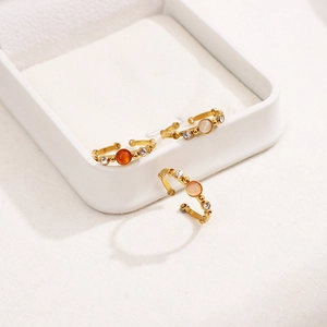Three-piece gold bamboo-style open rings with round opal-like stones and diamond accents