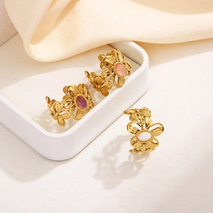 Detail of floral open rings in gold finish with pink, purple, and white stones