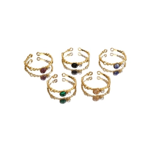 Five-piece gold adjustable flower rings set with colorful stones on mirror surface