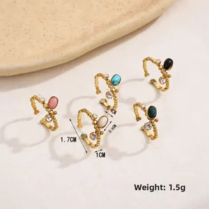 Detailed view of stackable oval natural stone rings in gold stainless steel finish